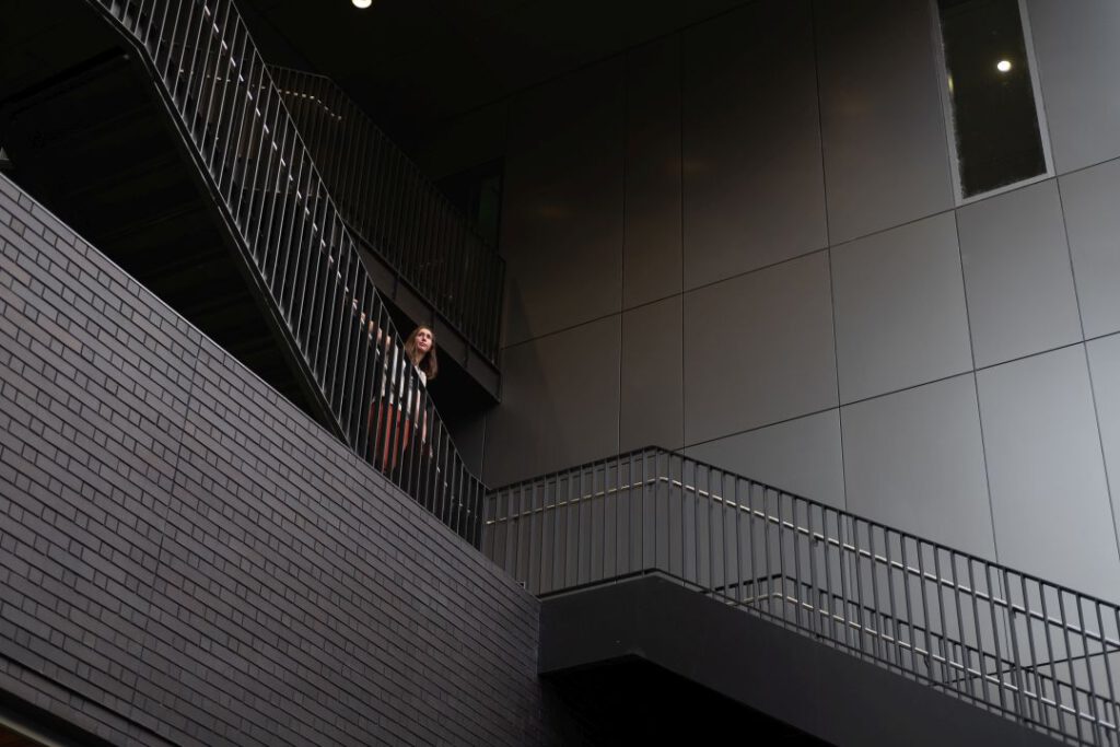 Person standing on white staircase