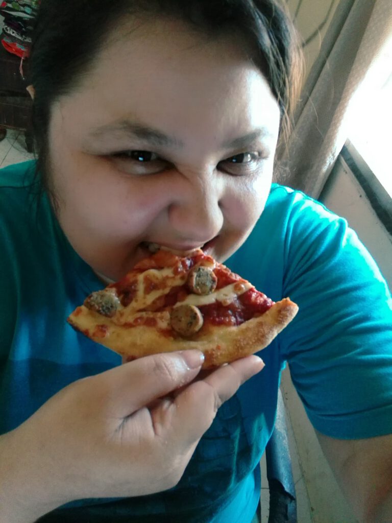 Person holding sliced of pizza